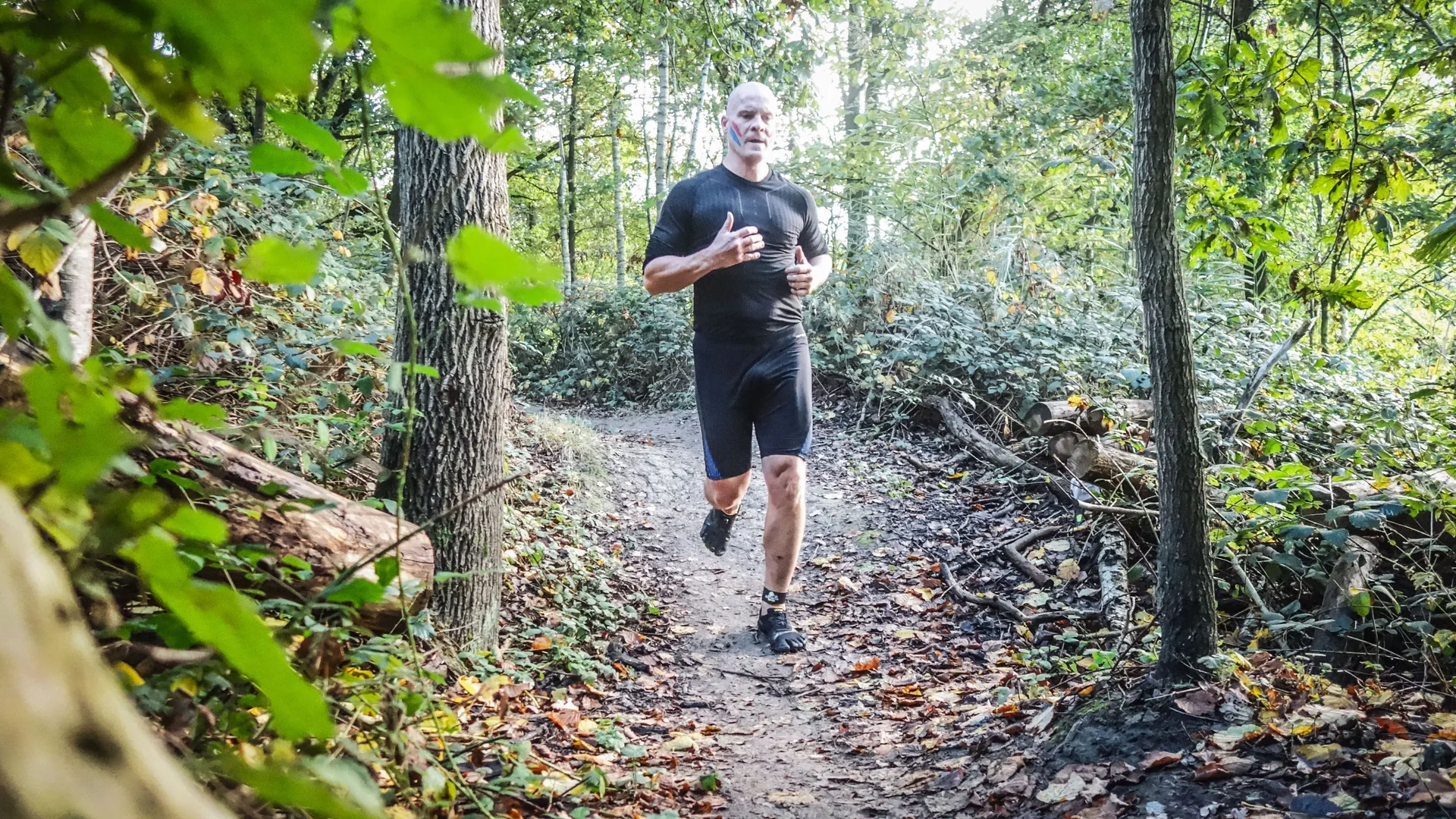 Bjorn running through a wet forest section of the Spartacus Run